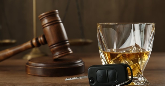 alcohol and keys with judges gavel